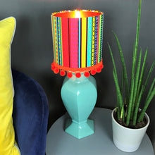 Load image into Gallery viewer, Multi-stripe fabric with mirror copper liner and optional orange pompom lampshade